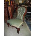 A Victorian spoonback drawing room chair with serpentine upholstered seat and button back within a