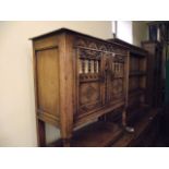 A good quality reproduction old English style side cupboard with distressed finish enclosed by a