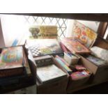 An extensive mixed collection of early 20th century jigsaw puzzles, board games, etc, to include a