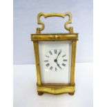 A brass carriage clock with enamel dial and 8 day time piece