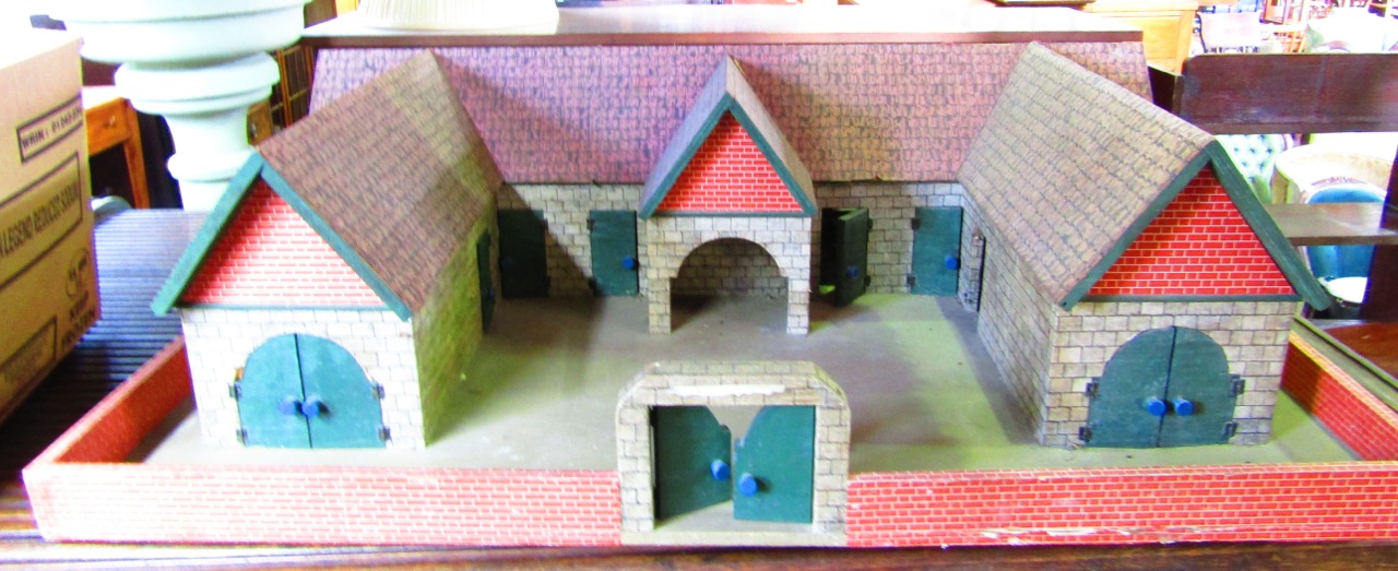 A substantial 20th century model farmyard in the form of a single U shaped building set within a