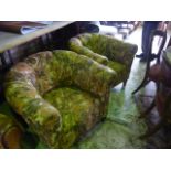 A pair of Edwardian tub chairs with rolled arms and floral upholstered finish raised on stained