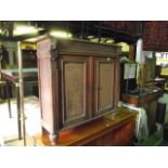 A 19th century oak side cupboard enclosed by a pair of rectangular fielded panelled doors beneath