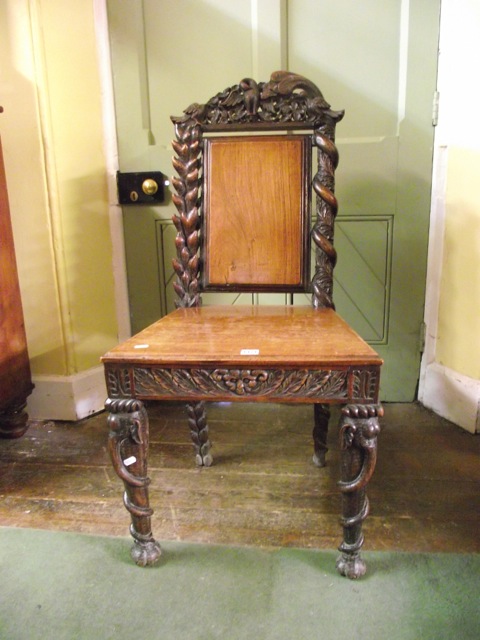 A 19th century Anglo-Indian walnut single chair with profusely carved detail, the cresting rail