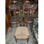 A pair of late Victorian walnut dining chairs with carved cresting rails over lyre shaped splats,