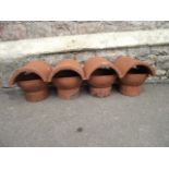 Four reclaimed terracotta chimney pot cowls with arched vents