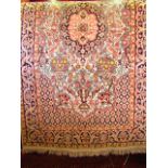 A small cream ground wool work rug with central medallion and foliate decoration set within