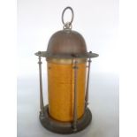 A brass framed ceiling lantern with turned column supports and later orange composite shade