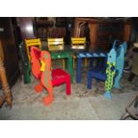 Two novelty brightly painted child's low wooden tables of rectangular form raised on square cut