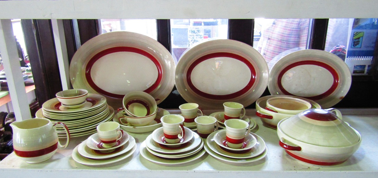 A quantity of Susie Cooper dinner and coffee wares with graduated grey and rust banded decoration,