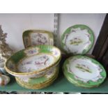 A set of six dessert plates with painted bird decoration within green, gilt and floral borders, with