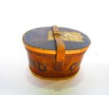 An early 20th century timber lidded box of oval form with stained detail and lettering reading