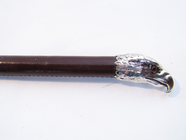 A stitched leather clad swagger stick with a silver collar marked The OCC Cane presented to OCDT