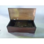 A late 19th century cylinder music box set within a hinged timber case with simulated rosewood