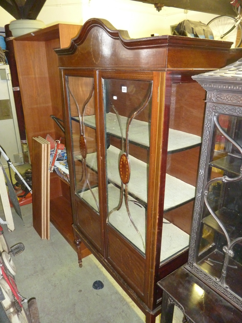 An inlaid Edwardian mahogany display cabinet with three quarter length glazed panelled doors on