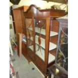 An inlaid Edwardian mahogany display cabinet with three quarter length glazed panelled doors on