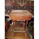 A vintage pitch pine child's school desk with cast iron fittings, hinged lid and shaped supports,