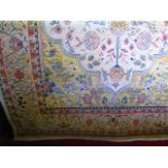 A contemporary cream ground wool carpet with foliate and floral decorated field set within