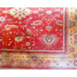 A good quality substantial contemporary wool carpet, the terracotta ground interspersed with