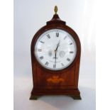 A Comitti Regency style mantel clock in a mahogany case with fleur de lys detail and lion mask