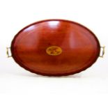 An oval Georgian mahogany serving tray with wavy edge border and inlaid detail