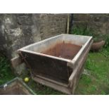 A vintage wooden framed and tin lined trough/bin of rectangular form with tapered sides and carrying