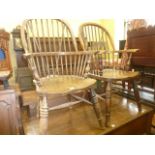 A pair of Windsor hoop and stick back elbow chairs in elm, ash and beech raised on ring turned and