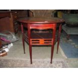 An Edwardian arts and crafts mahogany occasional table, the circular top raised on six square