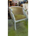 A French Empire style tub chair with carved swan detail raised on short sabre supports with