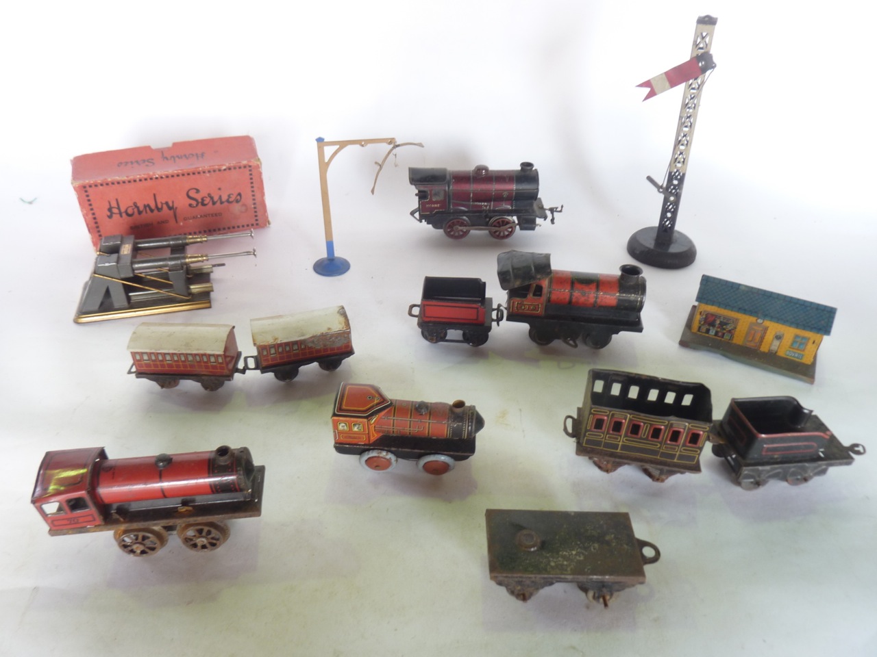 A quantity of antique 0 gauge model railway effects to include a tin plated engine stamped to