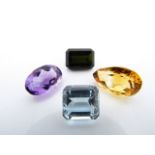 A collection of four unmounted gemstones, untested, comprising: a pear-shaped citrine, an oval