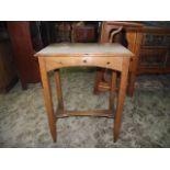 An arts and crafts style oak occasional table of rectangular form, the shaped frieze with pierced