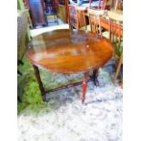 A Victorian walnut Sutherland table with oval moulded drop leaves raised on turned column supports