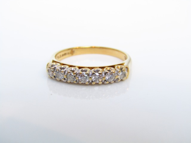 A seven stone diamond ring, set with round brilliant-cut diamonds weighing approximately 0.35cts