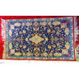 A small eastern wool rug with deep blue field decorated with complicated symmetrical foliate and