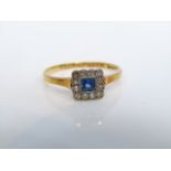 A sapphire and diamond ring, centred with a square-cut untested Ceylon type sapphire, within a