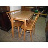 A set of four vintage Ercol elm and beechwood stickback kitchen chairs raised on turned, tapered and