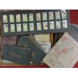 A collection of cigarette card albums including a series of Cricketer Caricatures by R I P,