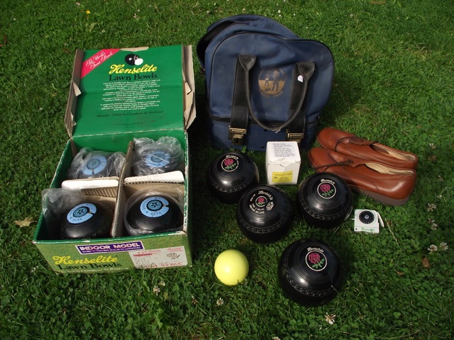 A set of four contemporary Henselite lawn bowls in original cardboard packaging together with a