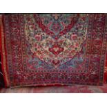 An eastern wool carpet with cream ground, highly decorated in trailing foliate and floral detail,