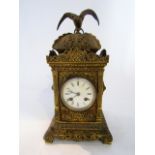 A Victorian cast brass mantel clock, the square cut case heavily detailed with foliate panels