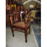 An Art Deco mahogany office chair with horseshoe shaped back, hide upholstered seat on square