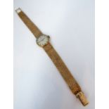 A lady's 9ct gold wristwatch, Omega, the circular silvered dial with black enamelled gilt baton