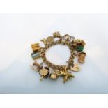 A 9ct gold charm bracelet, suspended with thirteen various 9ct gold charms, 73g