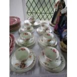 A collection of Coalport Junetime pattern floral teawares comprising: milk jug, sugar bowl, cake