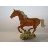 A Beswick model of a galloping palomino pony with impressed number to base 1374