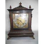 A Georgian style bracket clock with square brass dial and silvered chapter ring, the case with