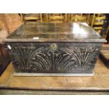 An antique oak bible box with hinged lid and carved foliate detail