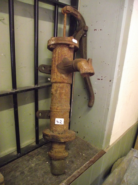 A small reclaimed cast iron hand operated water pump