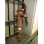 A small reclaimed cast iron hand operated water pump